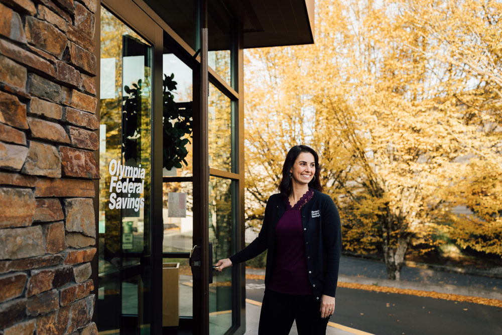 Branch Manager & Loan Officer Lindsey Bamba holds door open at local Westside Branch