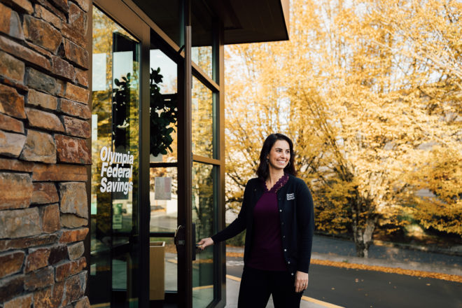 Branch Manager & Loan Officer Lindsey Bamba holds door open at local Westside Branch