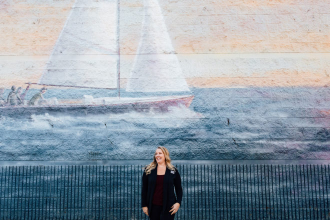 Olympia Federal Savings Loan Officer, Rebecca Bonneville, in front of a maritime mural in Mason County, Belfair, Washington.