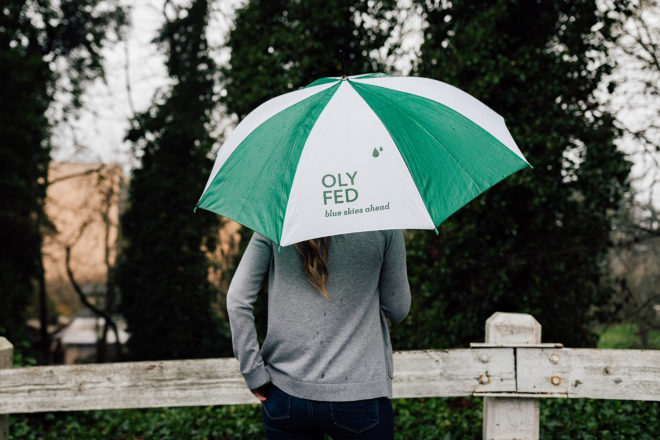 Kayla Rice of OlyFed holding an umbrella