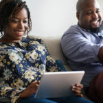 Couple reviewing iPad