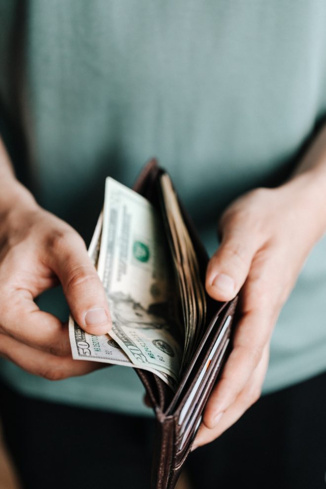 Man taking money out of wallet