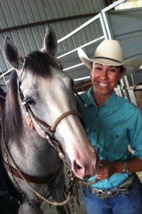 Carrie Whisler with her horse at a rodeo