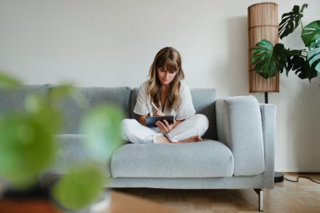 Woman sitting on coach reviewing information