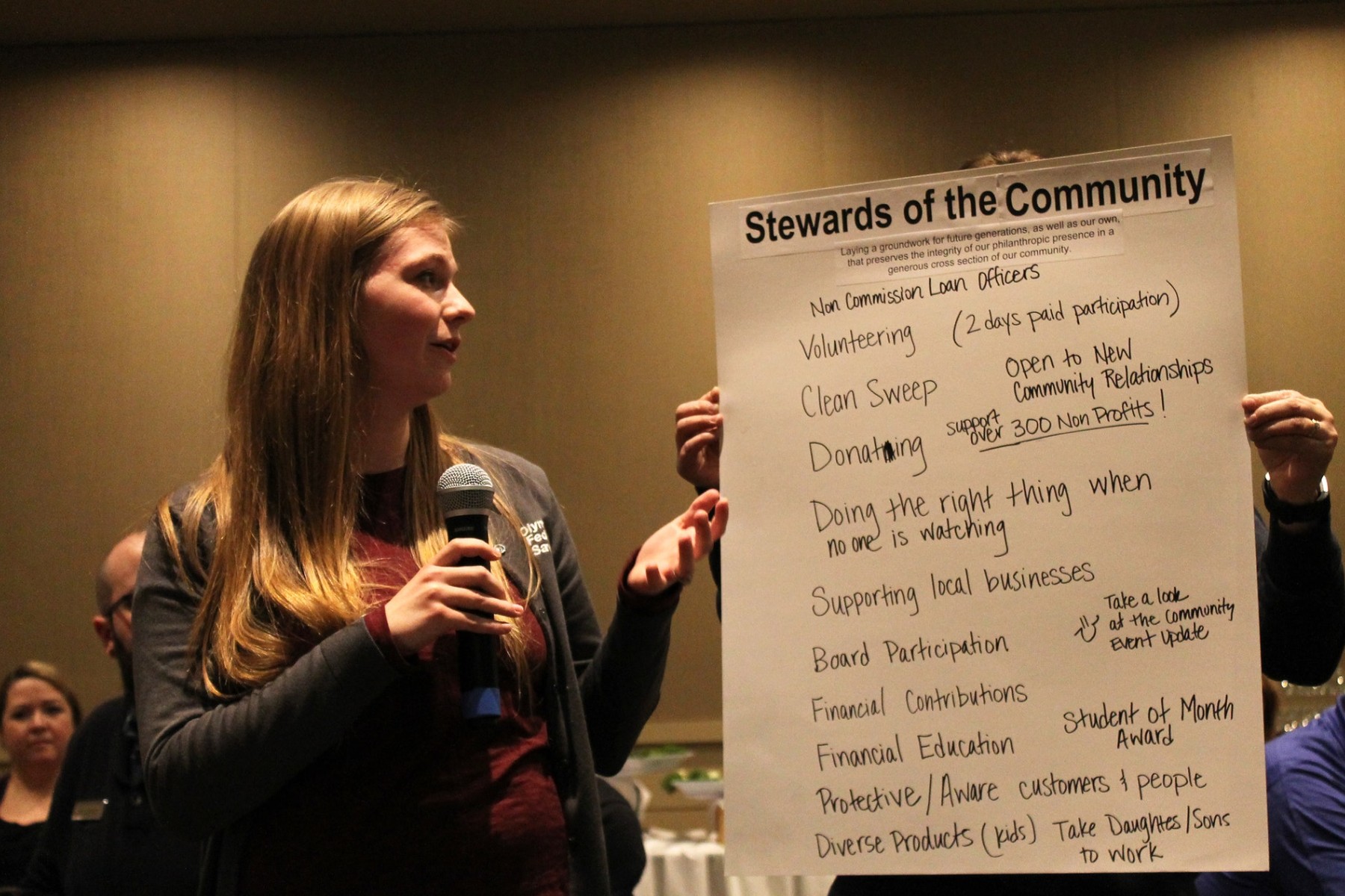 Tia presents an OlyFed working value at a Quarterly Celebration