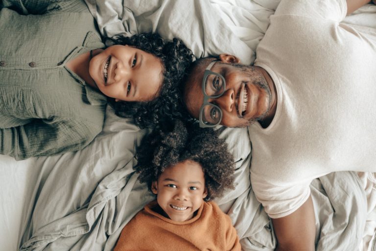 Dad with kids on bed