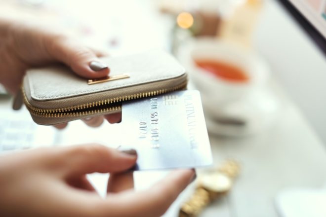 A person pulling a card from a digital reader