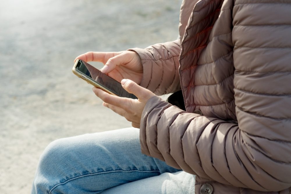 Woman on phone wearing warm jacket