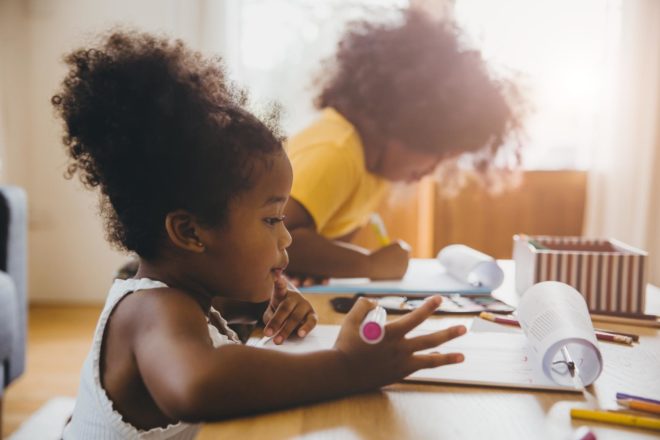 Girls coloring and playing