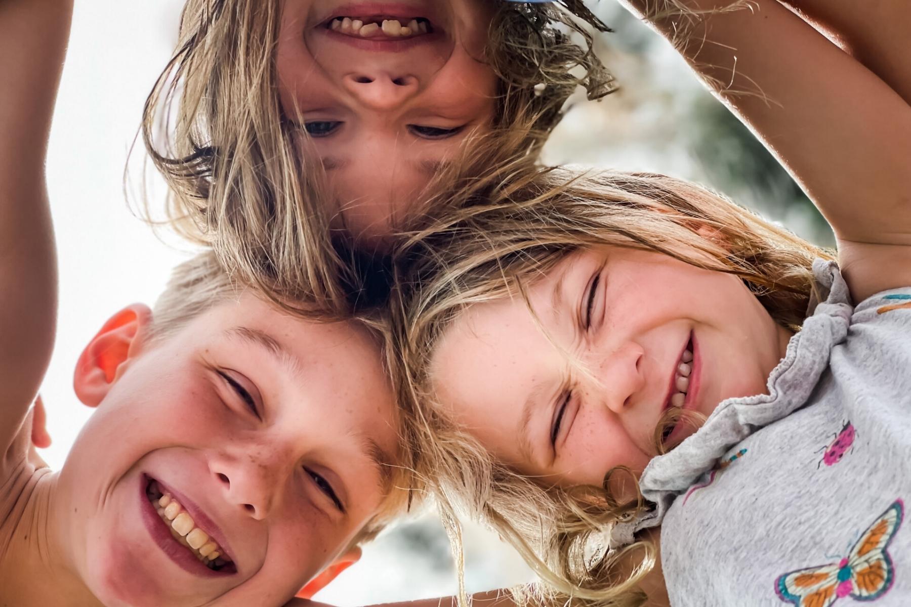 Children in a circle smiling