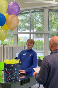 Justin with balloons being awarded Employee of the Quarter