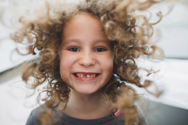 Girl looking into the camera with curly hair