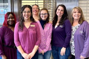 OlyFed downtown branch staff wear purple for Women's History Month