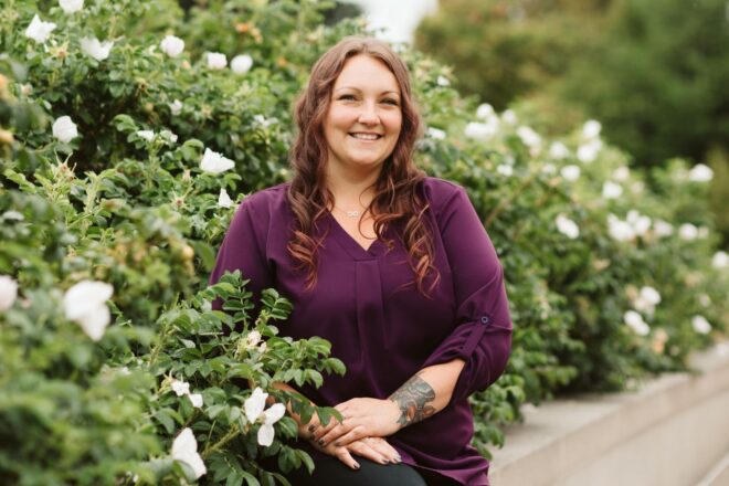 Dani Burns from OlyFed in front of flowers at the Washington state Capitol