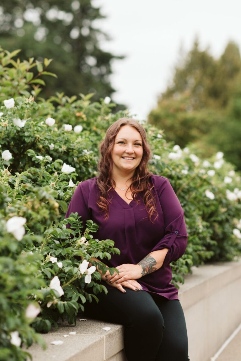 Dani Burns from OlyFed in front of flowers at the Washington state Capitol