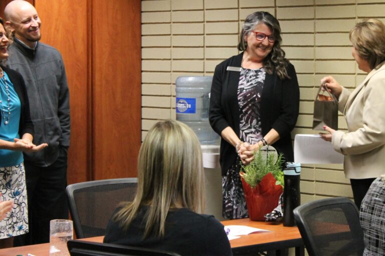 Gaylene VanWey receiving an award at the downtown OlyFed branch.