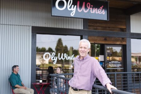 Business owner standing in front of OlyWines shop
