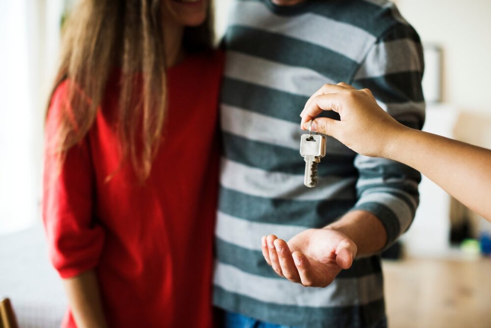 House keys handed to young couple.