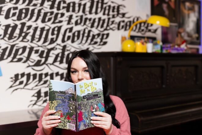 Woman reading a book at a coffee shop table