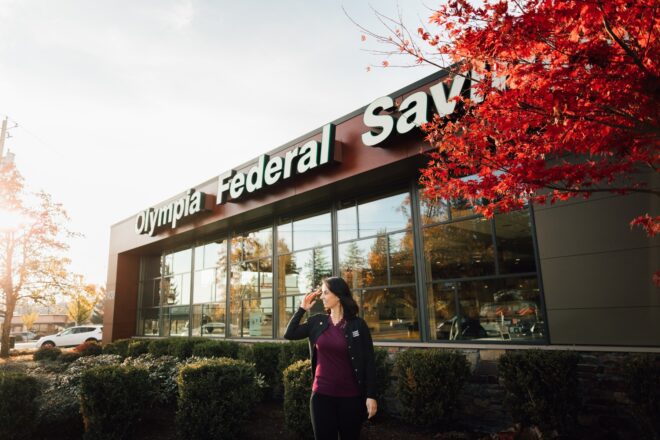 Woman banker in front of the Westside OlyFed branch