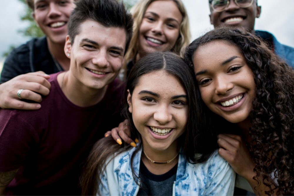 Teens smiling in a group