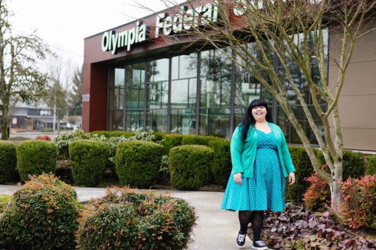 An OlyFed employee walking in front of the Westside branch