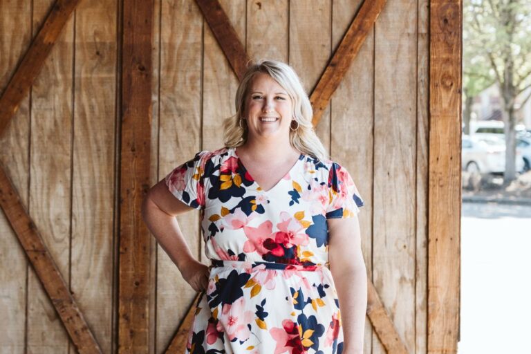 Woman standing in front of wood barn door