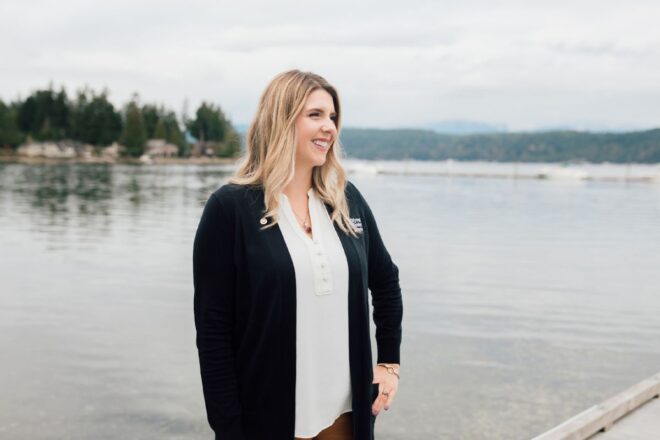 Woman standing on pier overlooking water