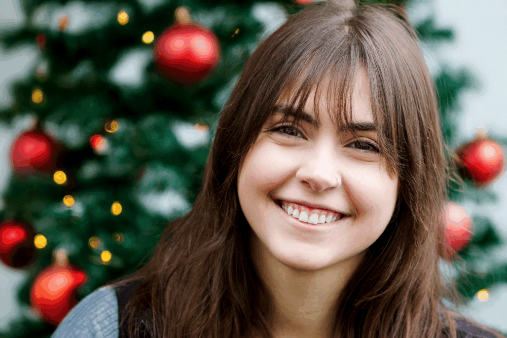 OlyFedder in front of a holiday tree